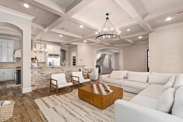 living room with light wood-type flooring, coffered ceiling, and a chandelier