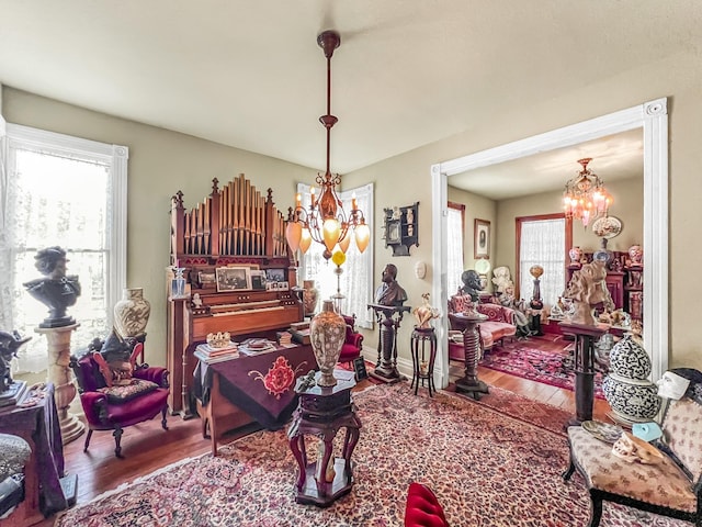 interior space featuring hardwood / wood-style flooring and a notable chandelier