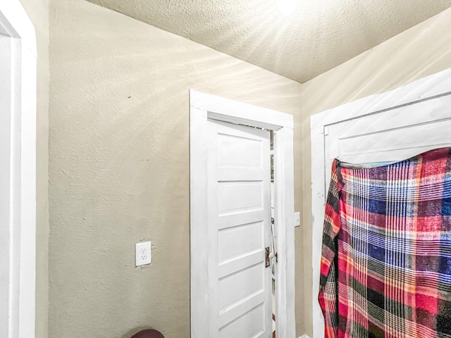 doorway with a textured ceiling