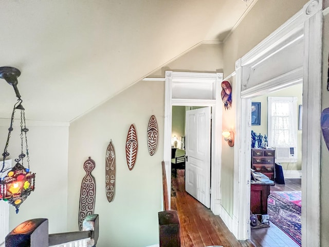 corridor featuring dark wood-type flooring and crown molding