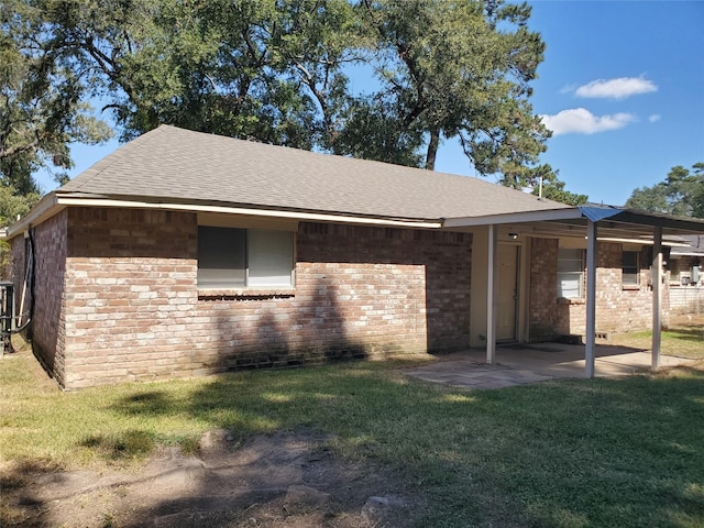 exterior space featuring a front lawn and a patio