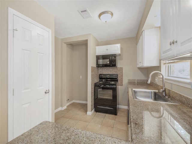 kitchen with black appliances, white cabinets, sink, and light tile patterned floors