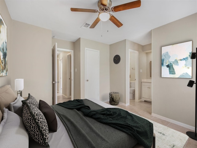 tiled bedroom with ensuite bath and ceiling fan