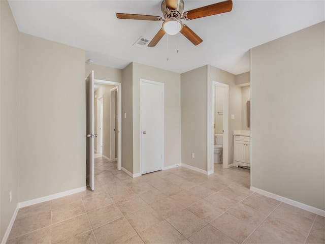 unfurnished bedroom featuring ceiling fan, light tile patterned flooring, a closet, and connected bathroom