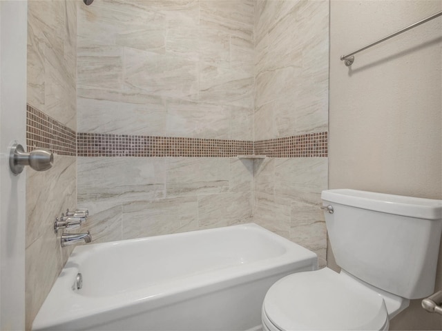 bathroom with toilet and tiled shower / bath combo