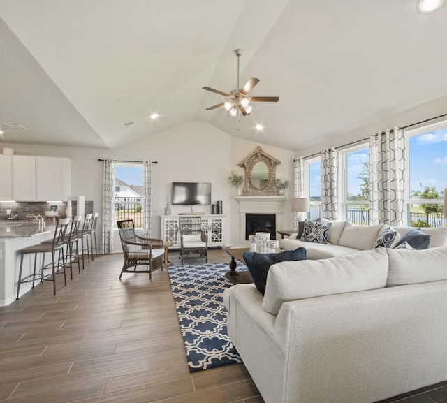 living room with vaulted ceiling and ceiling fan