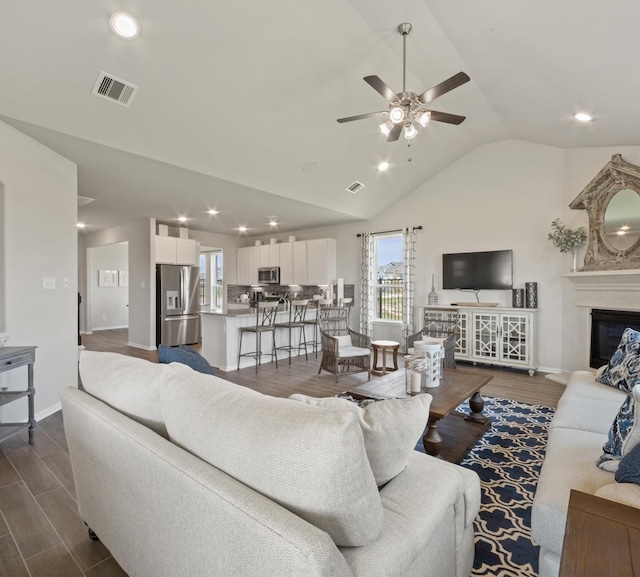 living room with ceiling fan and lofted ceiling