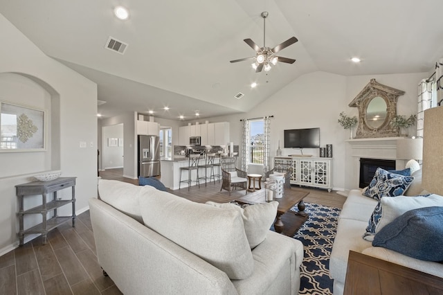 living room with ceiling fan and lofted ceiling