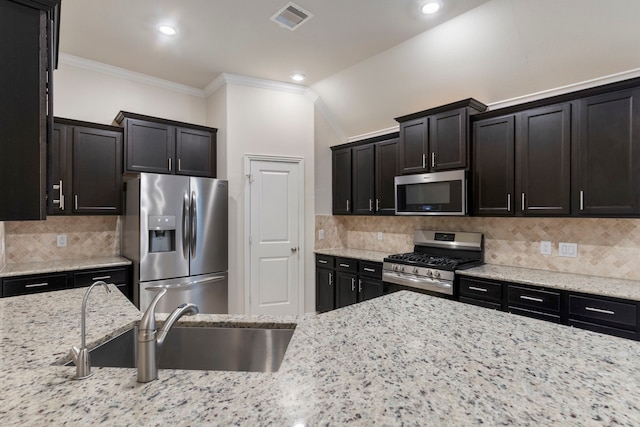 kitchen featuring decorative backsplash, sink, and appliances with stainless steel finishes