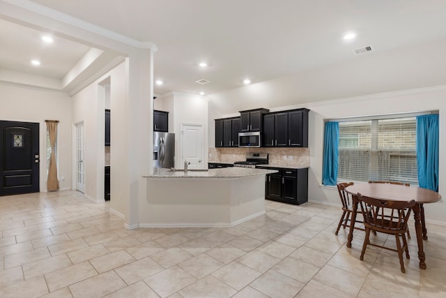 kitchen featuring light tile patterned floors, light stone countertops, backsplash, and appliances with stainless steel finishes