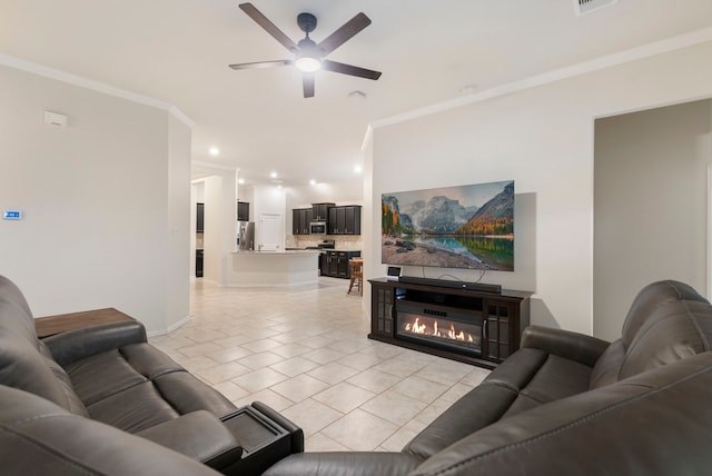 living room featuring ceiling fan, light tile patterned floors, and ornamental molding