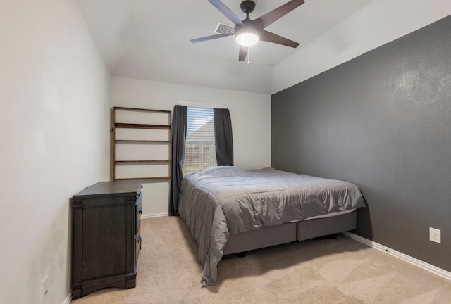 bedroom with ceiling fan, lofted ceiling, and light colored carpet