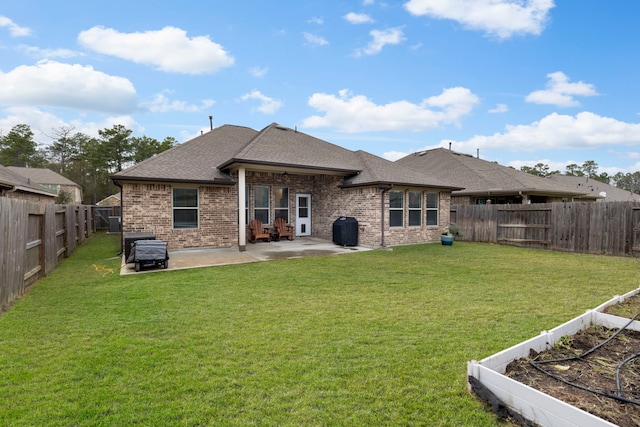 back of house with a patio area and a yard