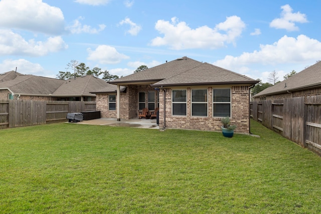 back of house featuring a patio area and a yard