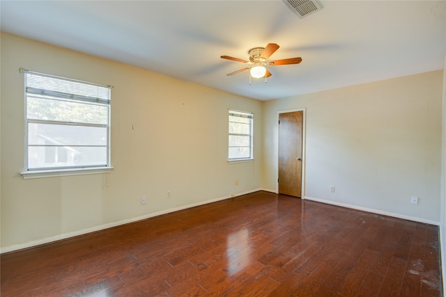 unfurnished room featuring dark wood-type flooring and ceiling fan