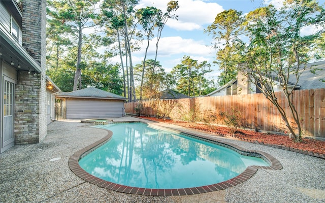 view of swimming pool with an in ground hot tub and a patio