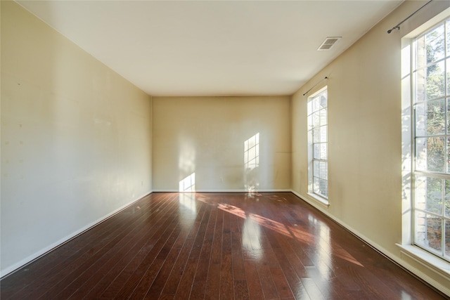 unfurnished room featuring dark hardwood / wood-style flooring