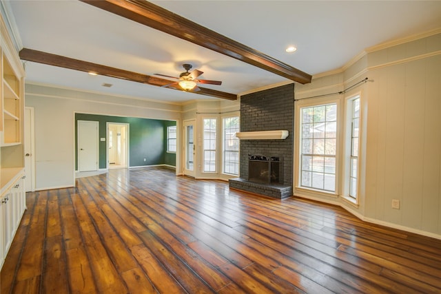 unfurnished living room with a fireplace, crown molding, dark wood-type flooring, and ceiling fan