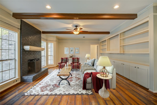 living room with ceiling fan, plenty of natural light, dark hardwood / wood-style flooring, and a brick fireplace