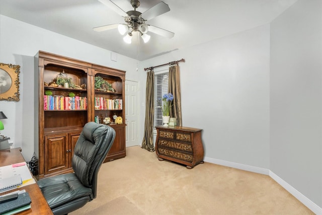 carpeted office space with ceiling fan