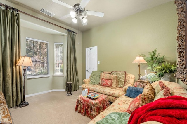 carpeted living room with ceiling fan