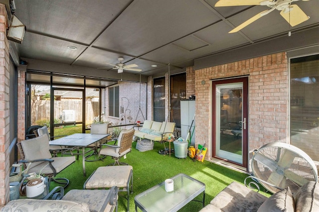 sunroom / solarium featuring ceiling fan