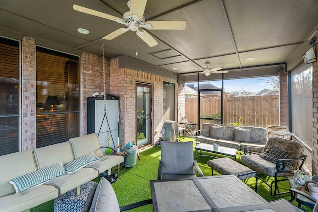 sunroom featuring ceiling fan