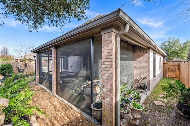 view of side of home featuring a sunroom