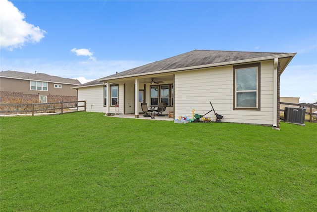 back of house featuring ceiling fan, a patio area, and a yard