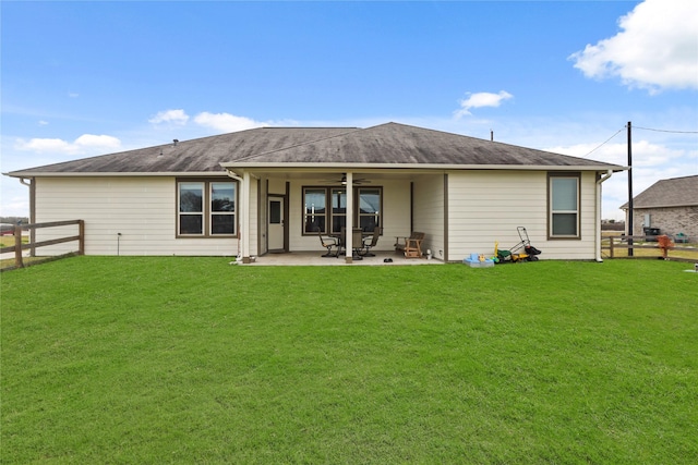 back of house featuring ceiling fan, a patio area, and a lawn