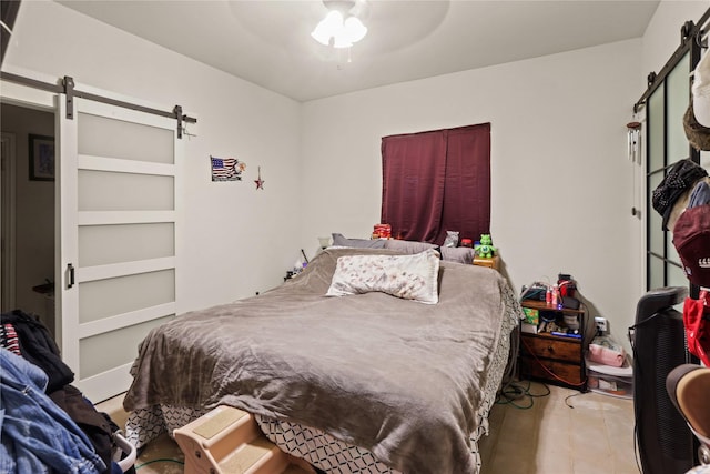 bedroom with ceiling fan and light tile patterned floors