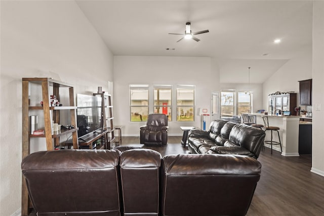 living room featuring ceiling fan, dark hardwood / wood-style flooring, and vaulted ceiling