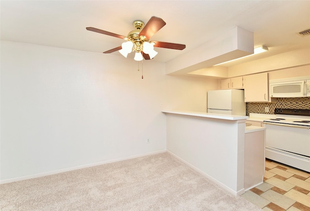 kitchen featuring ceiling fan, backsplash, kitchen peninsula, white appliances, and white cabinetry