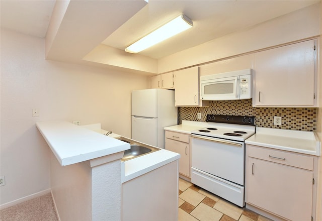 kitchen with white cabinetry, kitchen peninsula, backsplash, white appliances, and sink