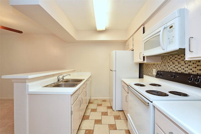 kitchen with backsplash, sink, white appliances, and white cabinetry