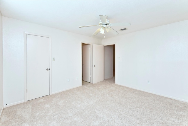 interior space featuring ceiling fan and light colored carpet