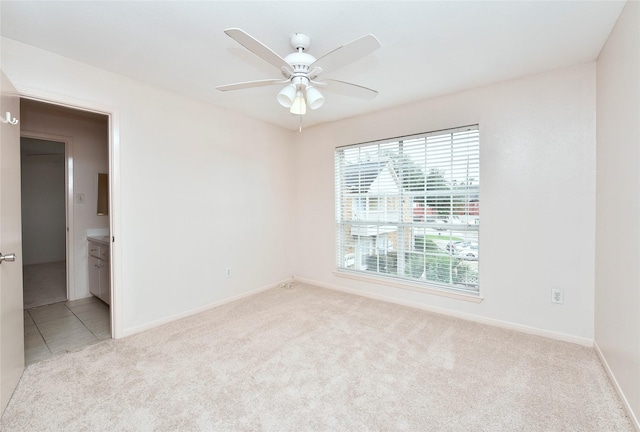 unfurnished room with light carpet and ceiling fan