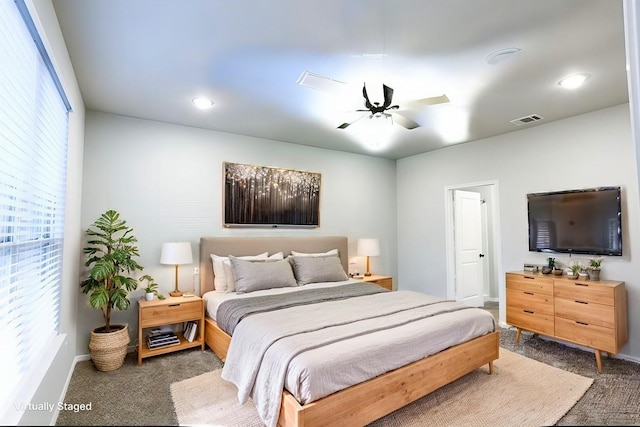 bedroom featuring ceiling fan and dark carpet