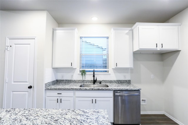 kitchen featuring white cabinets, dishwasher, dark hardwood / wood-style flooring, sink, and light stone counters