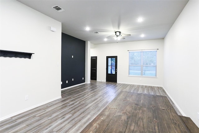 unfurnished living room with hardwood / wood-style flooring and ceiling fan