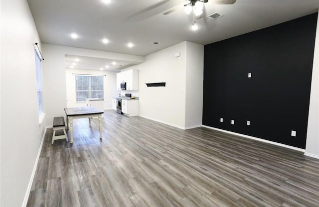 unfurnished living room featuring ceiling fan and hardwood / wood-style floors