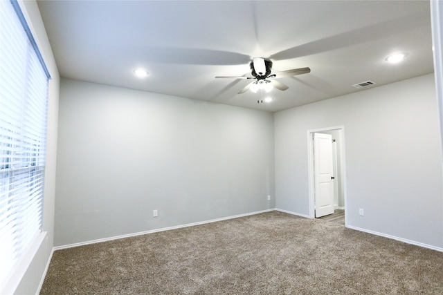 spare room featuring ceiling fan and carpet flooring