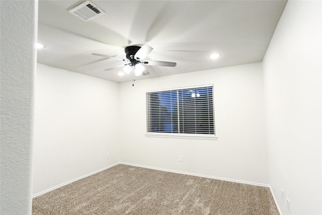 spare room featuring ceiling fan and carpet flooring