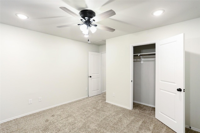 unfurnished bedroom featuring ceiling fan, a closet, and light colored carpet