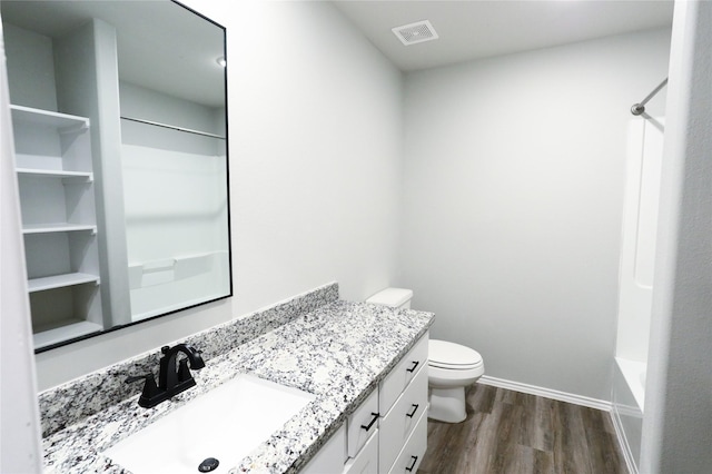 full bathroom featuring toilet, shower / bathtub combination, hardwood / wood-style floors, and vanity