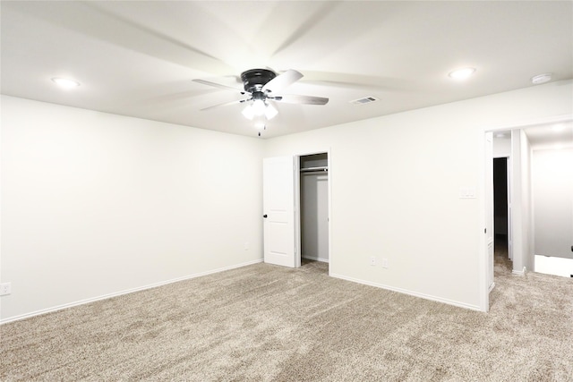 carpeted spare room with ceiling fan