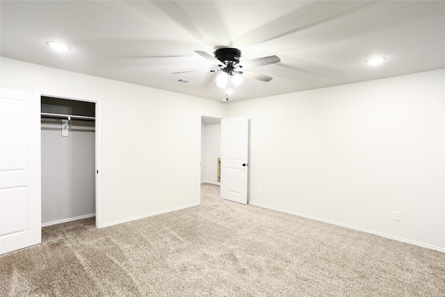 unfurnished bedroom featuring ceiling fan, a closet, and carpet flooring