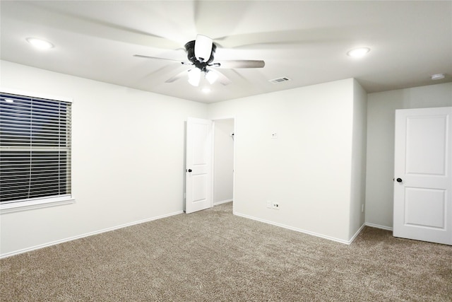 carpeted empty room featuring ceiling fan