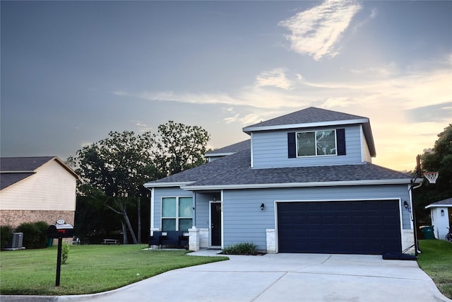 view of front facade with central AC unit, a garage, and a yard