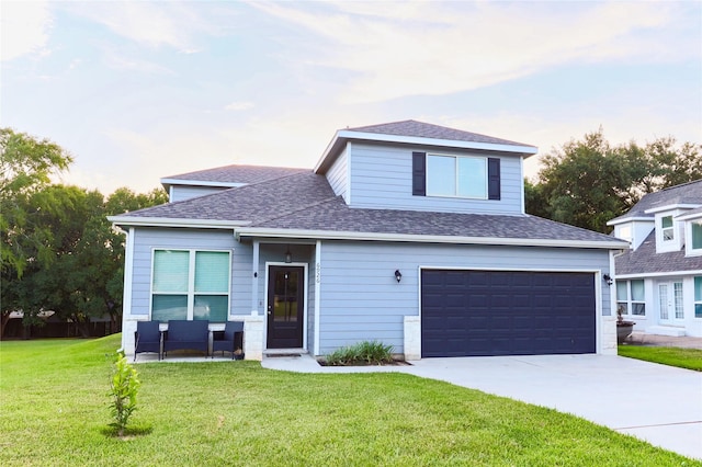 view of front of property with a garage and a front yard